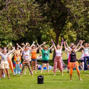 People participating in scilent disco in the park