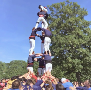 building different human towers as people climb on top of each other